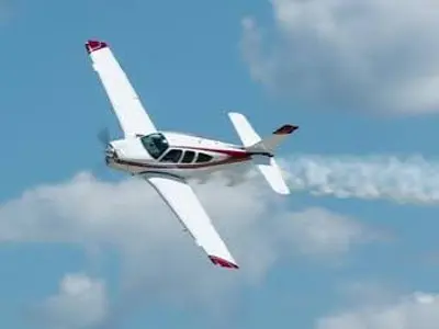 small aircraft flying at an angle against a blue sky